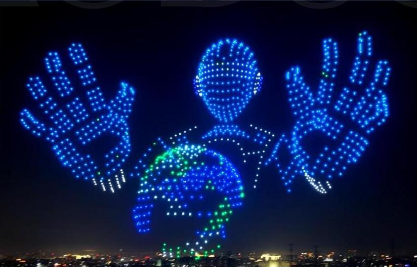 Custom drone formation shaped like hands and a figure